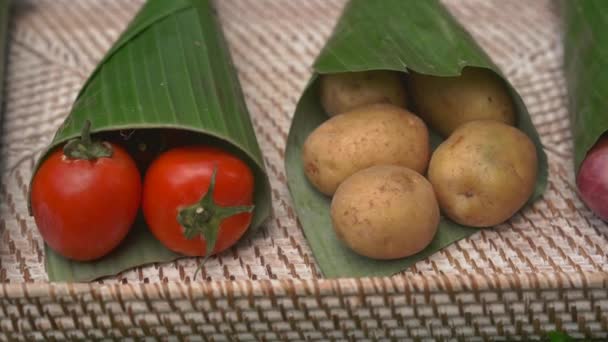 Umweltfreundliches Produktverpackungskonzept. Gemüse, in ein Bananenblatt gewickelt, als Alternative zu einer Plastiktüte. Null-Abfall-Konzept. Alternative Verpackungen — Stockvideo