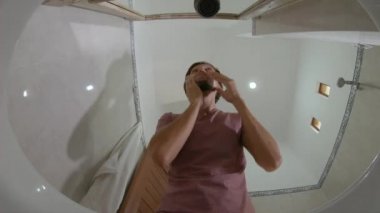 View from a sink -young man is shaving