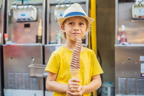 Little tourist boy eating 32 cm ice cream. 1 foot long ice cream. Long ice cream is a popular tourist attraction in Korea. Travel to Korea concept. Traveling with children concept