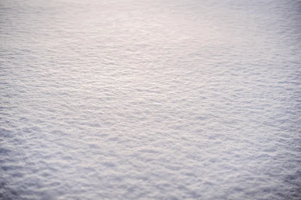 Pure white pristine snow. Texture of white snow with shadows