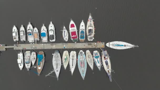 Aerial view on a yaght and boats parking in a calm bay — Stock Video