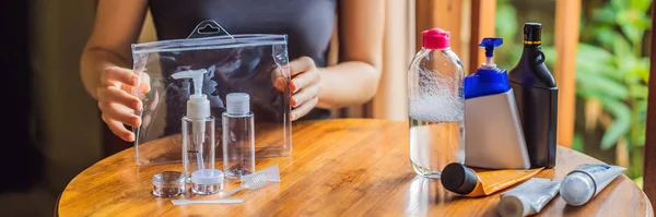 Travel kit for transporting cosmetics on an airplane. Cosmetics are ready to be poured into small bottles BANNER, LONG FORMAT — Stock Photo, Image