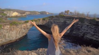 Genç bayan turist Endonezya 'nın Nusa Penida adasındaki ünlü turistik mekan olan Broken Beach' i ziyaret ediyor. Endonezya 'ya Seyahat