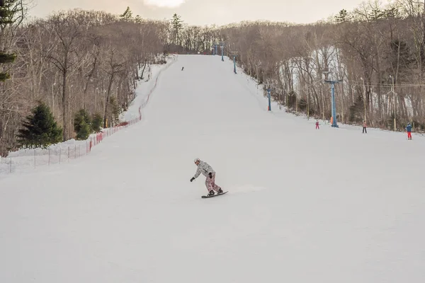 Erkek snowboardcu kışın bir kayak merkezinde — Stok fotoğraf