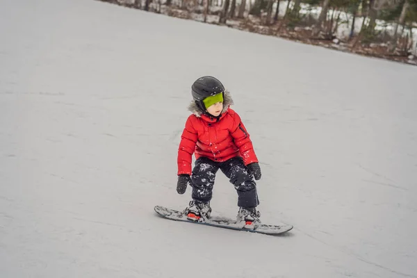 Petit garçon mignon snowboard. Activités pour les enfants en hiver. Sport d'hiver pour enfants. Mode de vie — Photo
