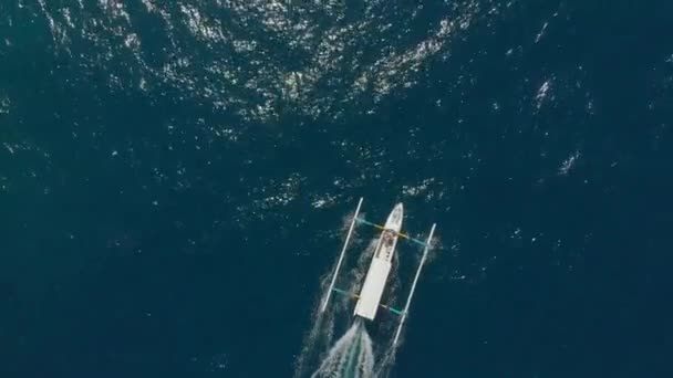 Aerial shot of traditional Balinese boats in an open sea. Travel to Indonesia concept — Stock Video