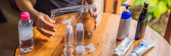 Travel kit for transporting cosmetics on an airplane. Cosmetics are ready to be poured into small bottles BANNER, LONG FORMAT — Stock Photo, Image