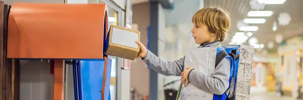 The boy plays that he is a postman BANNER, LONG FORMAT — Stock Photo, Image