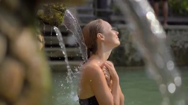 Young woman tourist visits the famous Banjar Hot Springs on the Bali island. Bali Travel Concept — 비디오