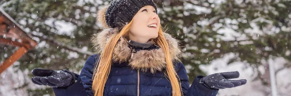 Young woman enjoys a winter snowy day in a snowy forest BANNER, LONG FORMAT