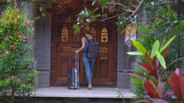 A woman traveler comes into traditional Balinese house. Travel to Bali concept — 비디오