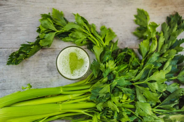 Celery Juice, Healthy Drink, bunch of celery on a wooden background