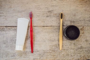 Activated charcoal powder VS plastic brush and toothpaste for brushing and whitening teeth. Bamboo eco brush