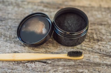 Activated charcoal powder for brushing and whitening teeth. Bamboo eco brush