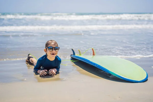 Junger Surfer, glücklicher Junge am Strand mit Surfbrett — Stockfoto