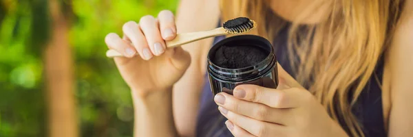 Young woman brush teeth using Activated charcoal powder for brushing and whitening teeth. Bamboo eco brush BANNER, LONG FORMAT — Stock Photo, Image