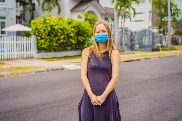 一个戴着医疗面具的小镇上的女人因为大流行的结肠炎 — 图库照片