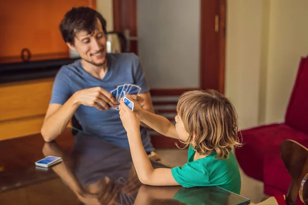 Happy Family Playing Board Game At Home