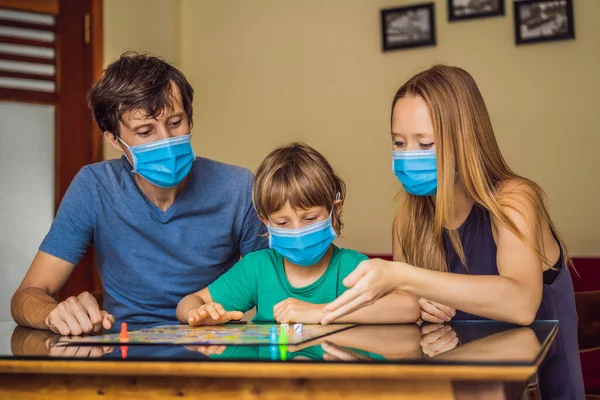 Happy Family Playing Board Game At Home. Stay at home due to quarantine. Coronovirus infection