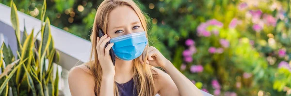 Coronavirus. Woman in quarantine for coronavirus wearing protective mask. Shes working from home and using video call. Video conference BANNER, LONG FORMAT — Stock Photo, Image