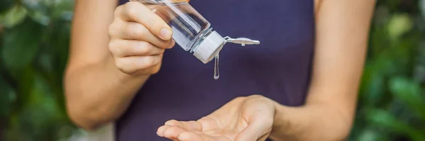 Womens hands using wash hand sanitizer gel BANNER, LONG FORMAT