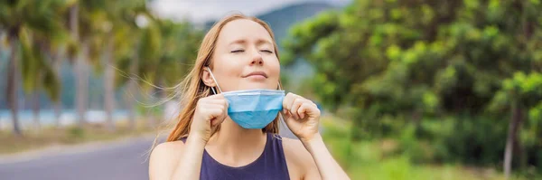 Quarantine is over concept. Woman taking off mask outdoor. We are safe. Coronavirus ended. We won. No more quarantine. Breathe deep. Take off the mask. Coronavirus is over BANNER, LONG FORMAT — Stock Photo, Image