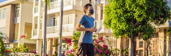 Runner wearing medical mask, Coronavirus pandemic Covid-19. Sport, Active life in quarantine surgical sterilizing face mask protection. Outdoor run on athletics track in Corona Outbreak. Keep your