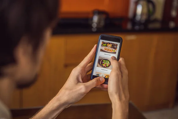 man orders food for lunch online using smartphone