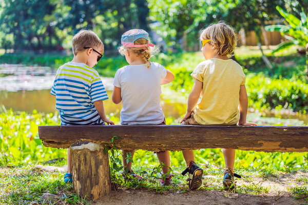 Coronavirus is over. Quarantine weakened. Take off the mask. Now you can go to public places. Children rest during a hike in the woods