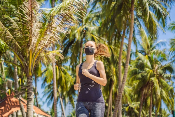 Woman runner wearing medical mask. Running in the city against the backdrop of the city. Coronavirus pandemic Covid-19. Sport, Active life in quarantine surgical sterilizing face mask protection