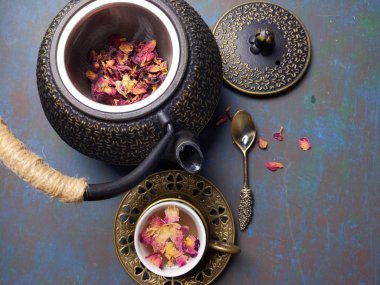 Metal çaydanlıklı bir fincan gül çayı..