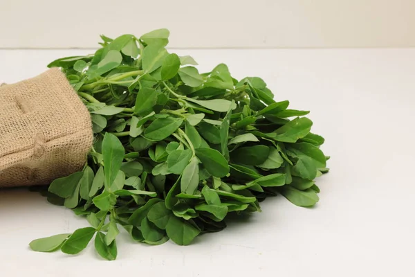 Fenugreek leavs or Methi leaves in a burlap bag — Stock Photo, Image