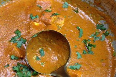 A pan full of Paneer Butter Masala , a rich and creamy Indian di