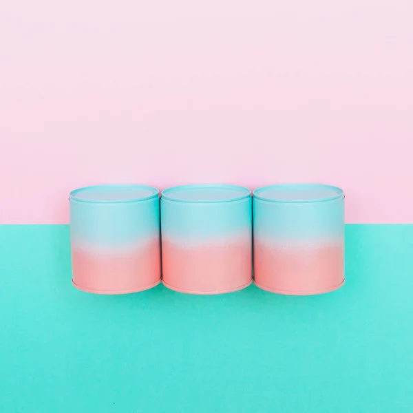 three pink and blue cans