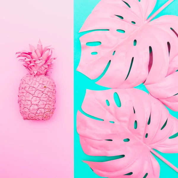 Painted pineapple with tropical palm leaves in vibrant pink color on turquoise and pink background.