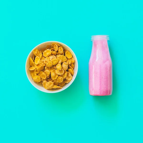 cornflakes in plate with pink drink for breakfast
