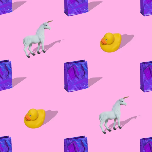 Seamless pattern made with various presents, unicorns and rubber ducks on bright light and soft pink background with strong shadows. Happy birthday concept