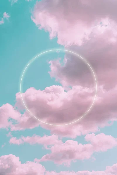 Aesthetic art collage with beautiful turquoise sky with pink clouds and circle light frame. Minimal creative concept of angel paradise