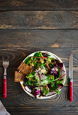 Fresh organic green quinoa salad bowl on dark wooden background clipart