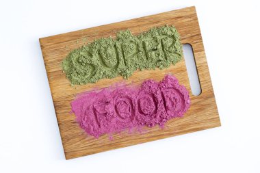 Superfoods word with green and pink powders  clipart