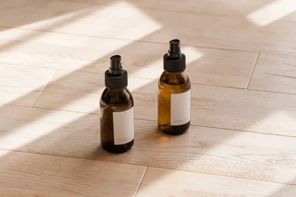Butelki kosmetyczne ciemnobursztynowe na drewnianym stole — Zdjęcie stockowe