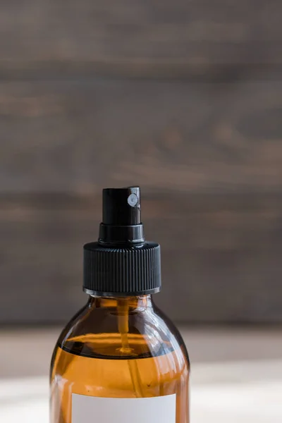 Cosmetic dark amber bottle on wooden  table Stock Picture