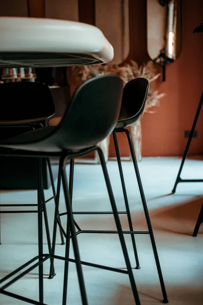 Black bar chairs in colorful minimalist designer interior — Stock Photo, Image