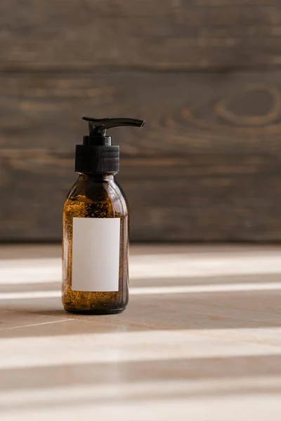 Cosmetic dark amber bottles on wooden  table