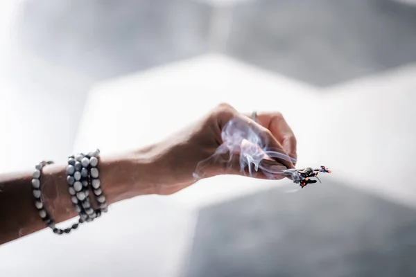 Woman's hands smudging burning sage — Stock Photo, Image