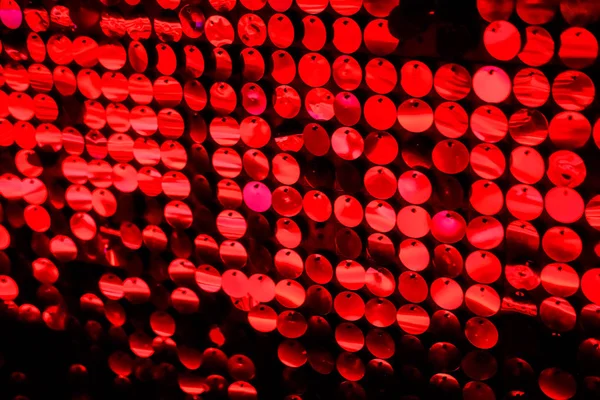 Disco wall background in neon led dot lighting, glitter effect, vibrant colorful pattern in red colour