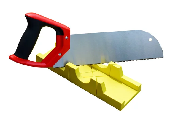 Hand saw and a yellow miter box to make precise mitre cuts in a — Stock Photo, Image