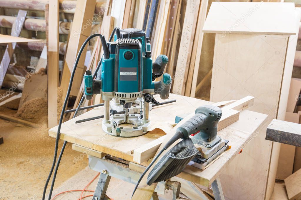 Tools in the carpentry workshop: electric milling cutter, grinde