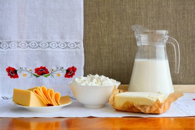 Still life of dairy products on background of towel with embroid clipart