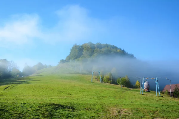 View of Pass Nimchich in sunny autumn morning, blue sky and fog — Stock Photo, Image